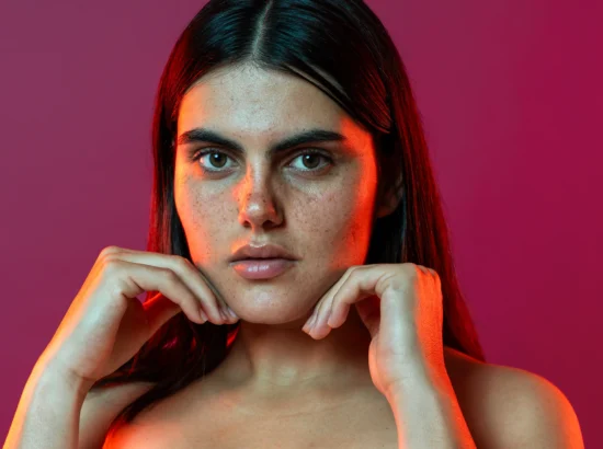 young-woman-touching-face-showing-freckles-in-stud-2026-01-09-12-04-09-utc copy
